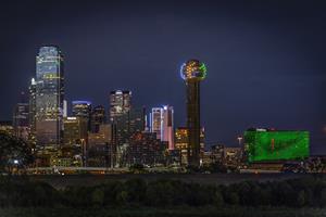Dallas' city skyline awash in North Texas Giving Day green and blue