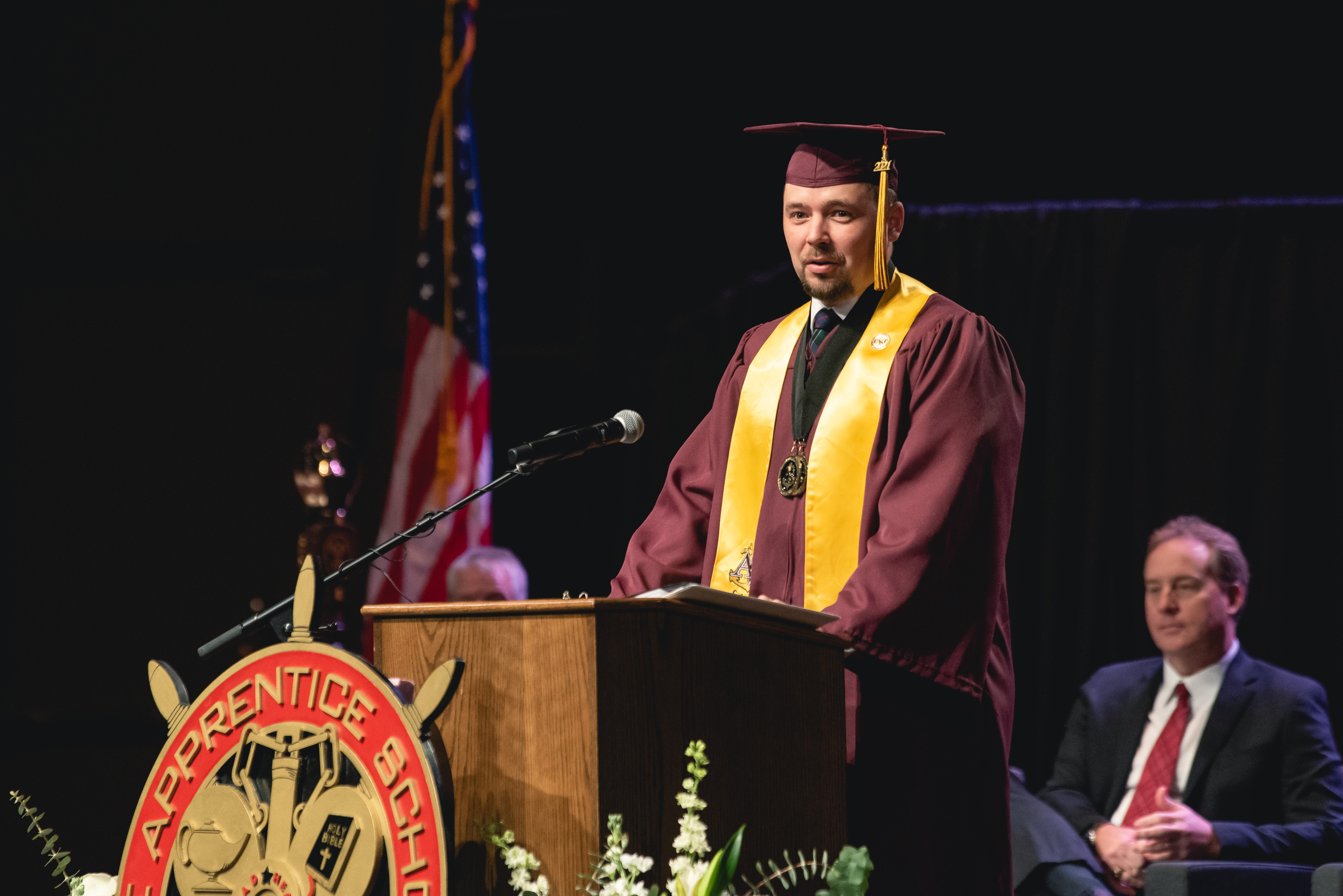Chris Rose (Homer L. Ferguson Award Recipient) speaks during the 2022 Apprentice School at Newport News Shipbuilding Commencement Ceremony.
