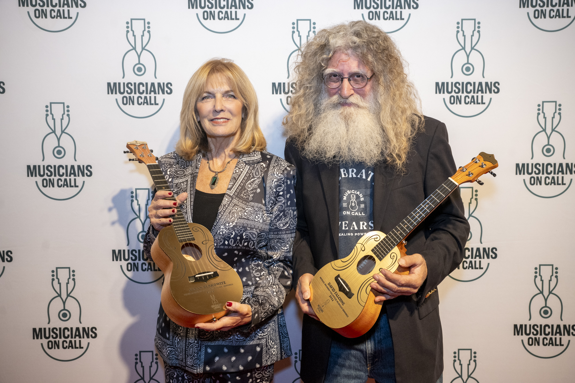 Susan Berkowitz receives the Vivek J. Tiwary Volunteer Guide Award and David Falcone receives the Michael Solomon Volunteer Musician Award during Musicians On Call's 