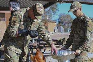 U.S. Air Force Tech Sgt. Brian Munson, Holloman 5/6 Council president, and U.S. Air Force Airman 1st Class Zachary Jepsen, 49th CES HVAC apprentice, prepares a turkey for a Thanksgiving meal for dorm residents at Holloman Air Force Base, New Mexico, Nov. 17, 2022. This year, Defense Logistics Agency Troop Support sent more than 9,100 whole turkeys and 41,745 pounds of roasted turkeys to locations around the world for troops to enjoy for Thanksgiving. (U.S. Air Force photo by Airman 1st Class Corinna Diaz)