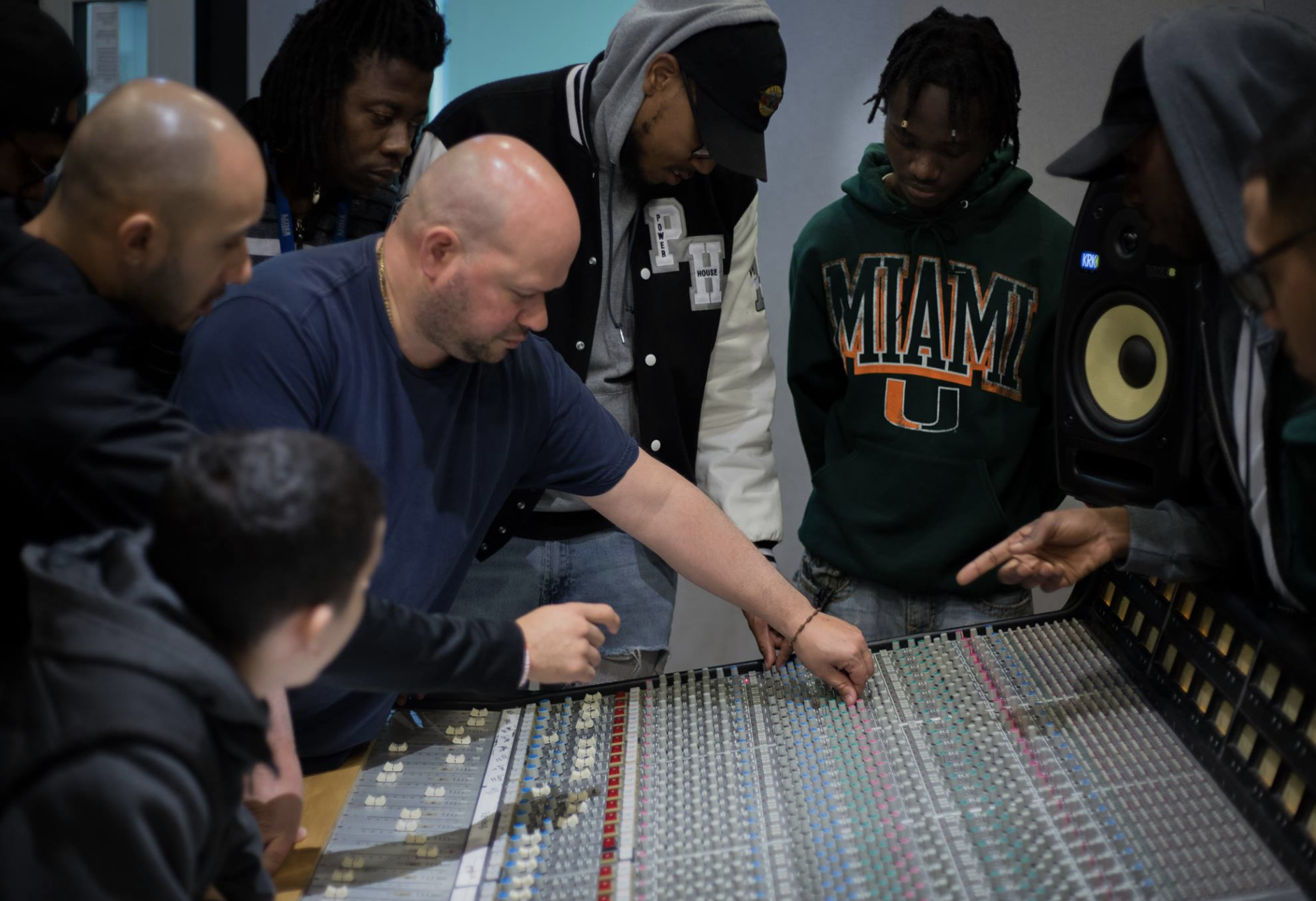 The Audio Technology Diploma program is led by Latin GRAMMY® award-winning instructor Guillermo Lefeld. Lefeld is seen here (center), introducing his students to the SSL 4000 G console at SAE Institute Miami. 