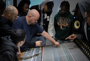 The Audio Technology Diploma program is led by Latin GRAMMY® award-winning instructor Guillermo Lefeld. Lefeld is seen here (center), introducing his students to the SSL 4000 G console at SAE Institute Miami.