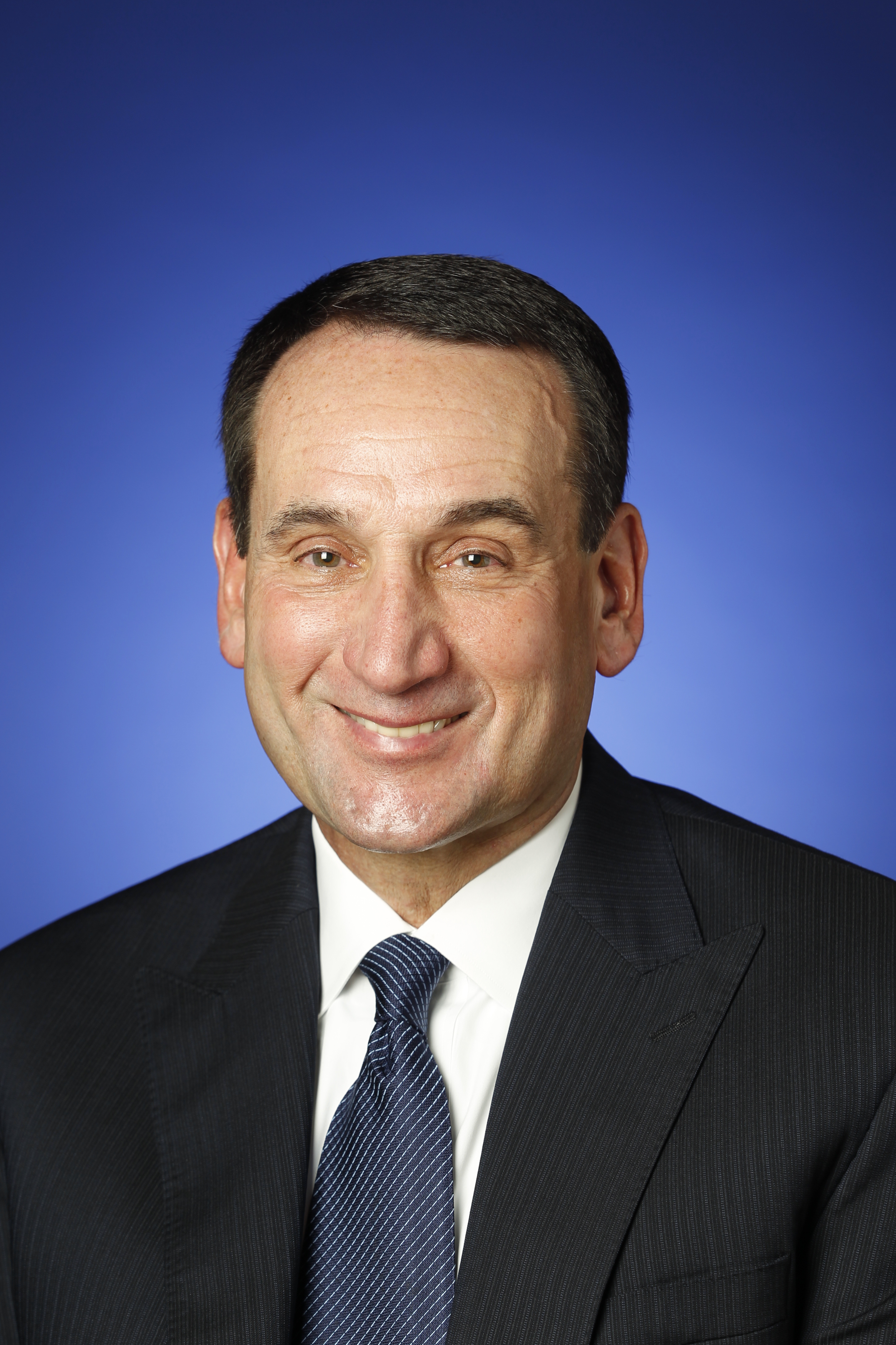 Headshot of a man in a suit and tie