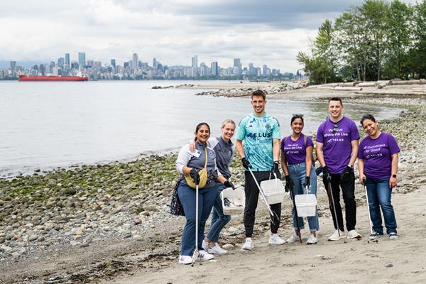 Vancouver Whitecaps FC team member, Thomas Hasal and TELUS team members, collecting waste at Spanish Banks beach