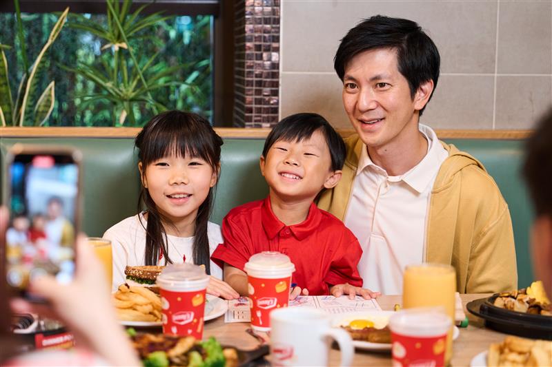 Father and two children, girl and boy, enjoying Denny’s family night