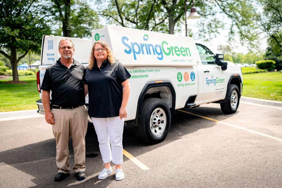 Kenny and Lisa Gute stand in front of a SpringGreen service truck celebrating 10 years as SpringGreen franchise owners serving the Ames and Boone, Iow