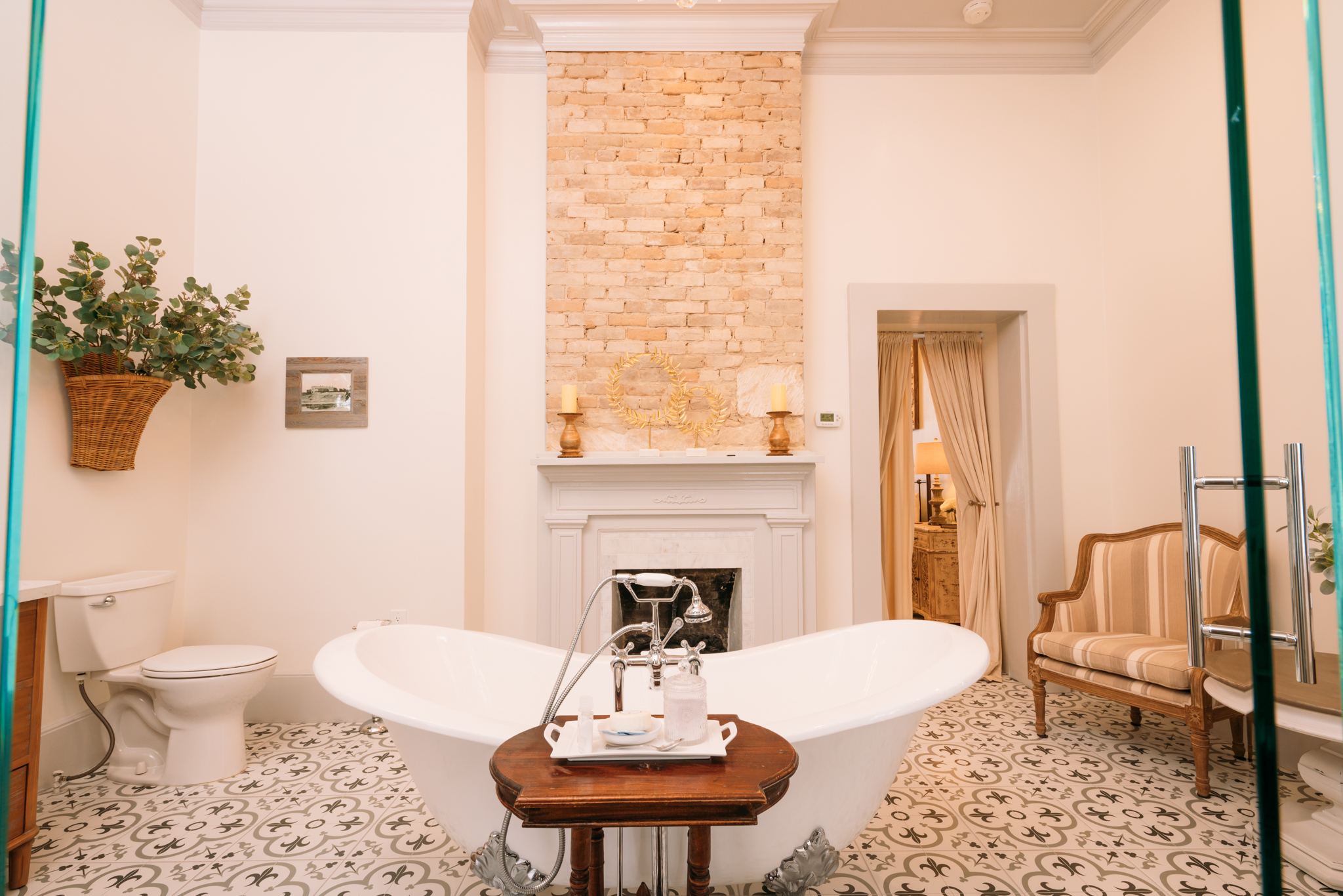 Relax in the Sarah Reed Suite's luxurious oversized clawfoot bathtub by the cozy fireplace. This suite consists of 2 of the 4 original rooms in the historic hotel.