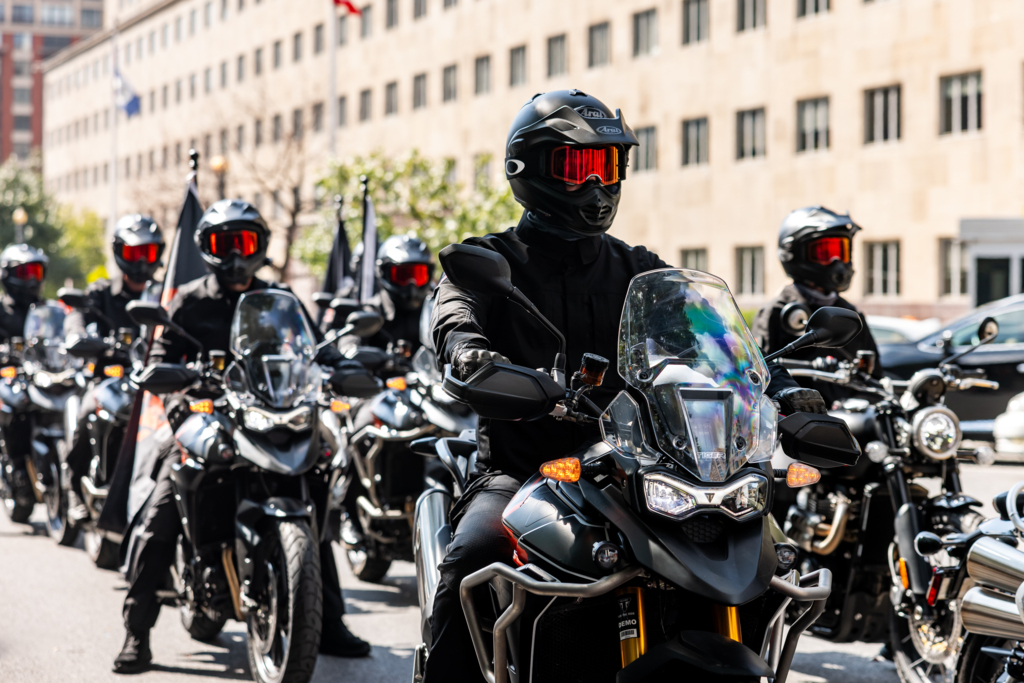 16 Triumph Motorcycles escorting Call of Duty NEXT Buses in Washington, DC.