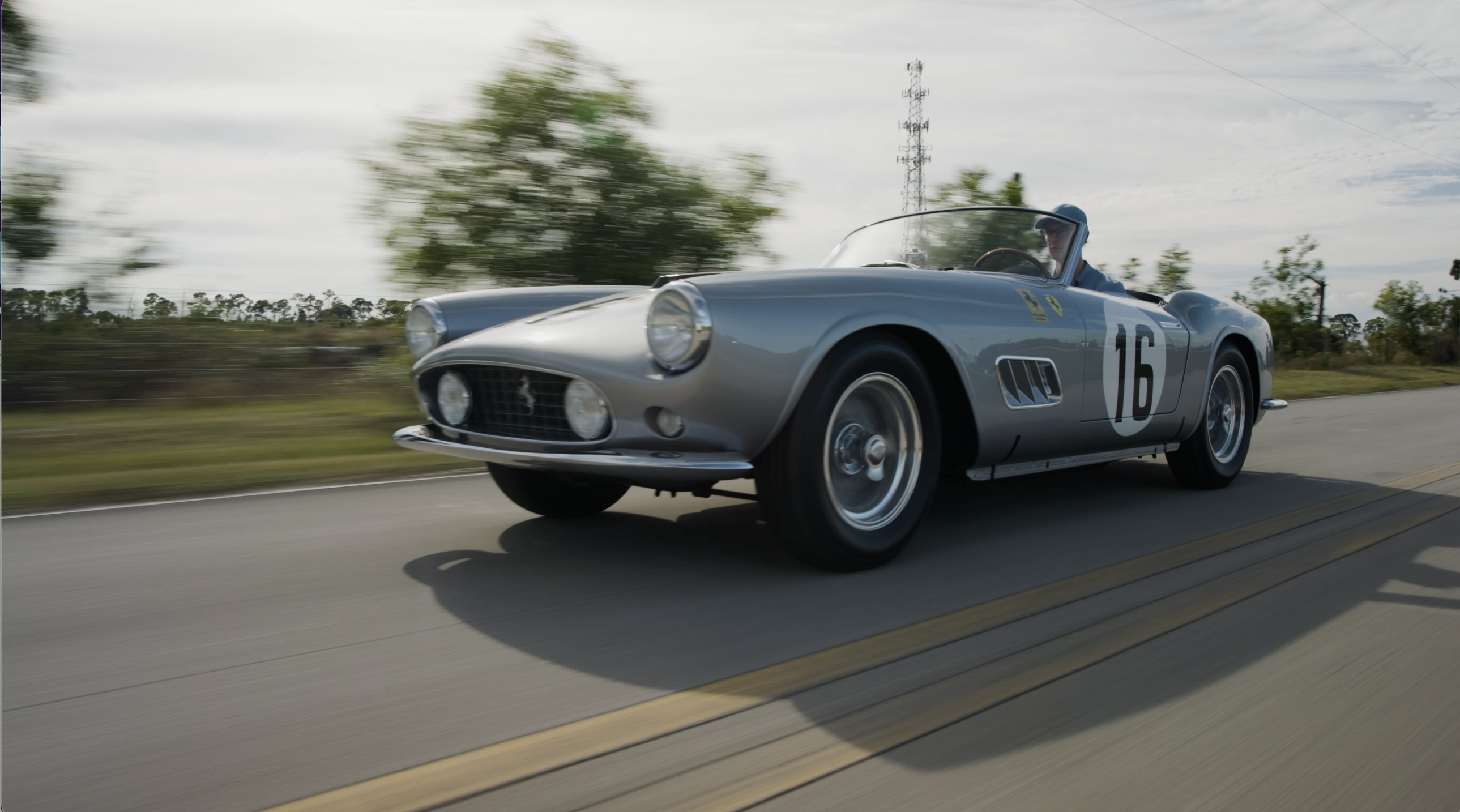 The 1959 Ferrari 250 GT LWB California Spider Competizione on the road ahead of Amelia Auction