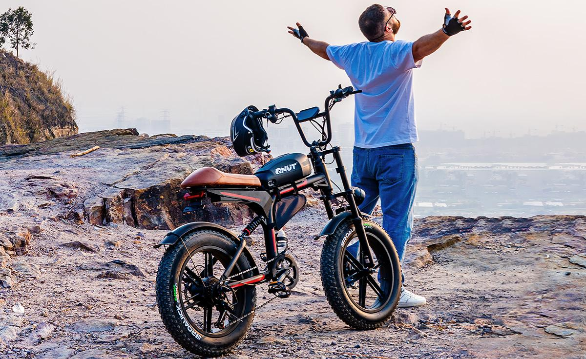 A man with a Qnut eBike at the beach.