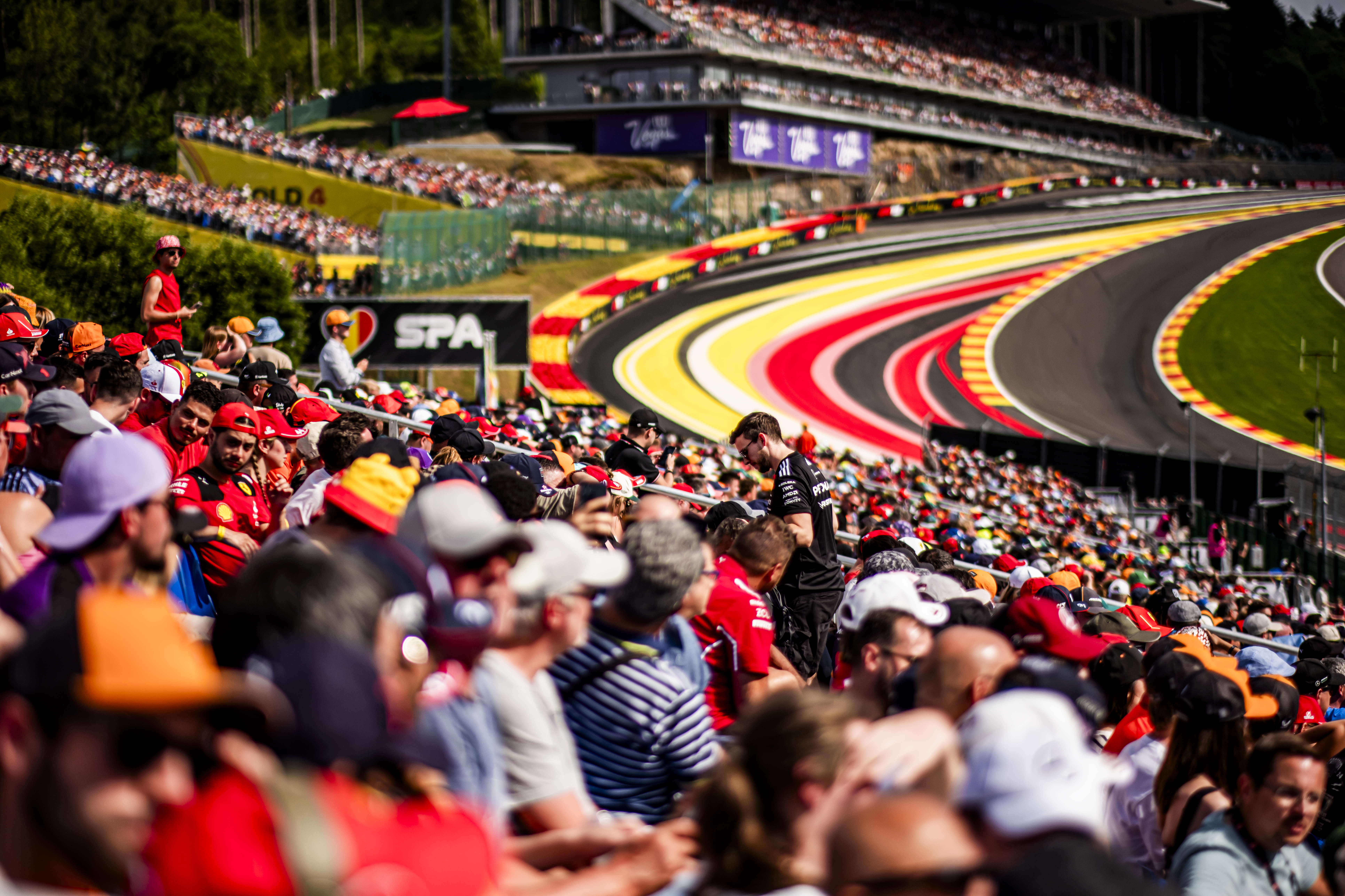 A photo of the crowd watching the Spa Grand Prix Formula1 race at one of the track's turns.