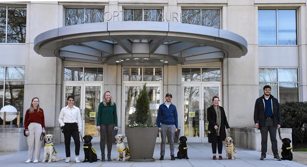 Six SPA employees with Future Guide and Service Dog Puppies