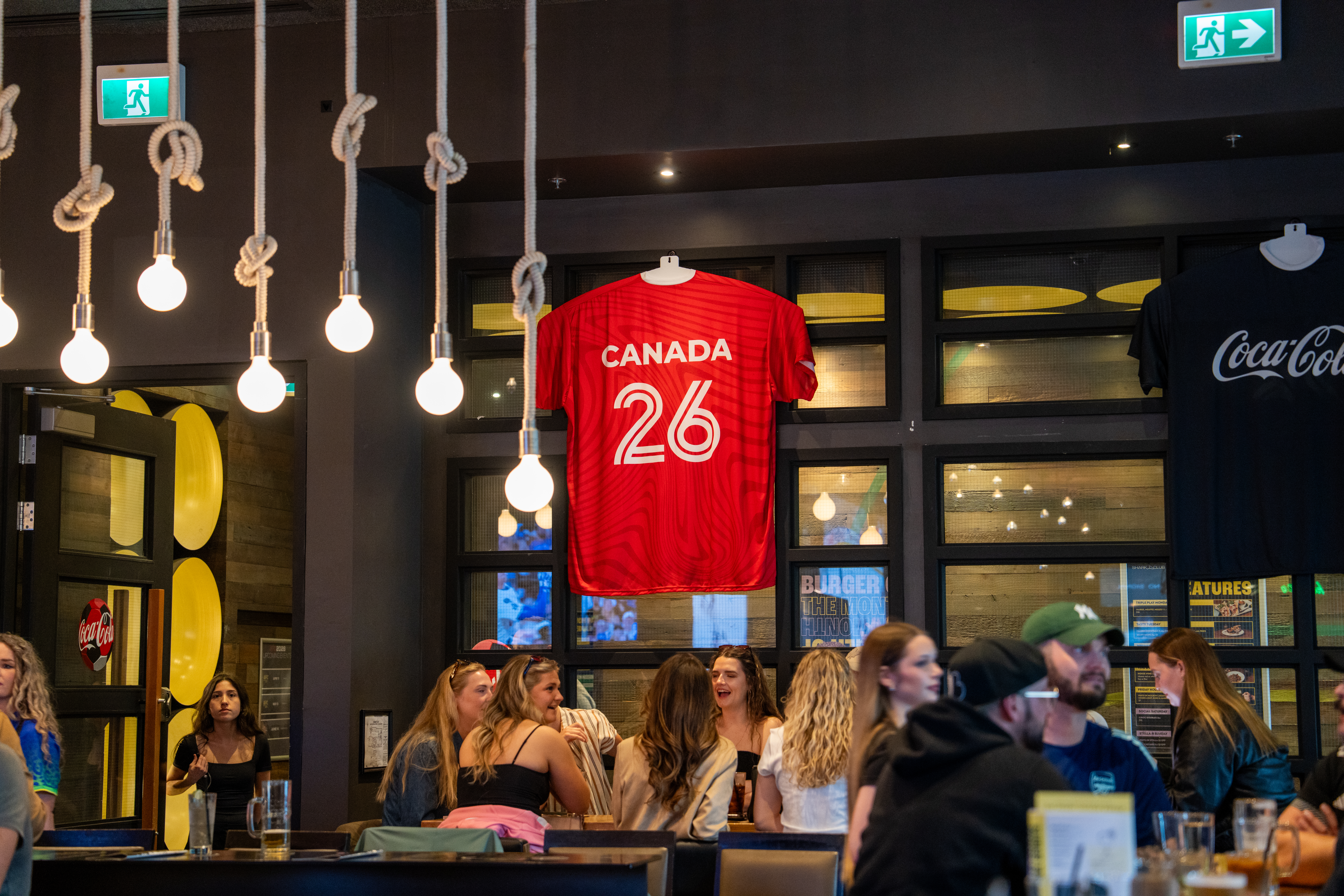 Canada and Coca-Cola shirts hanging in Shark Club