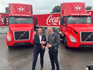 Volvo Trucks North America president, Peter Voorhoeve, (left) joins Stephen du Toit, president and chief operating officer of Coca-Cola Canada Bottling Limited (right), as the beverage manufacturer takes delivery of Volvo VNR Electric trucks during a special fifth birthday celebration for the company held September 19, 2023 at Coke Canada's distribution centre in east Montreal.