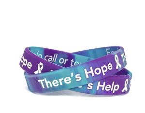This purple and turquoise wristband displays the message, "There's Hope There's Help Prevent Suicide" and the message on the inside reminds the wearer of the new suicide prevention hotline, "For help call or text 988"