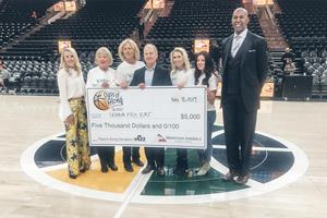 Sterling Nielsen, president and CEO at Mountain America Credit Union presents a $5,000 to USANA Kids Eat at the November 18, 2019, Utah Jazz game. 