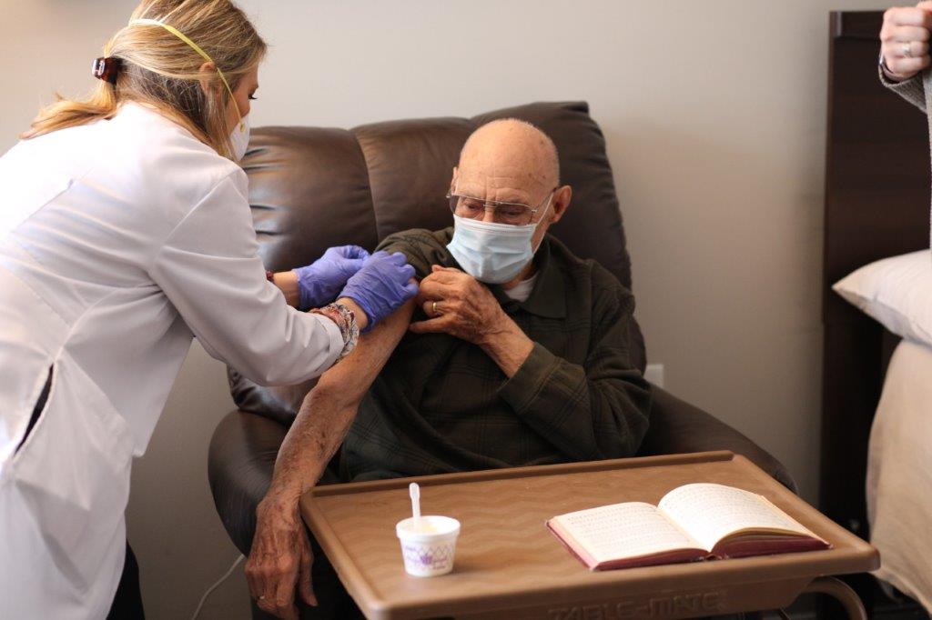 Raymond Gano, a resident at Eclipse Senior Living's Elmcroft of Martinsburg community, receives his vaccination.