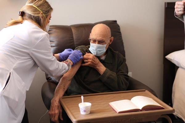 Raymond Gano, a resident at Eclipse Senior Living's Elmcroft of Martinsburg community, receives his vaccination. 