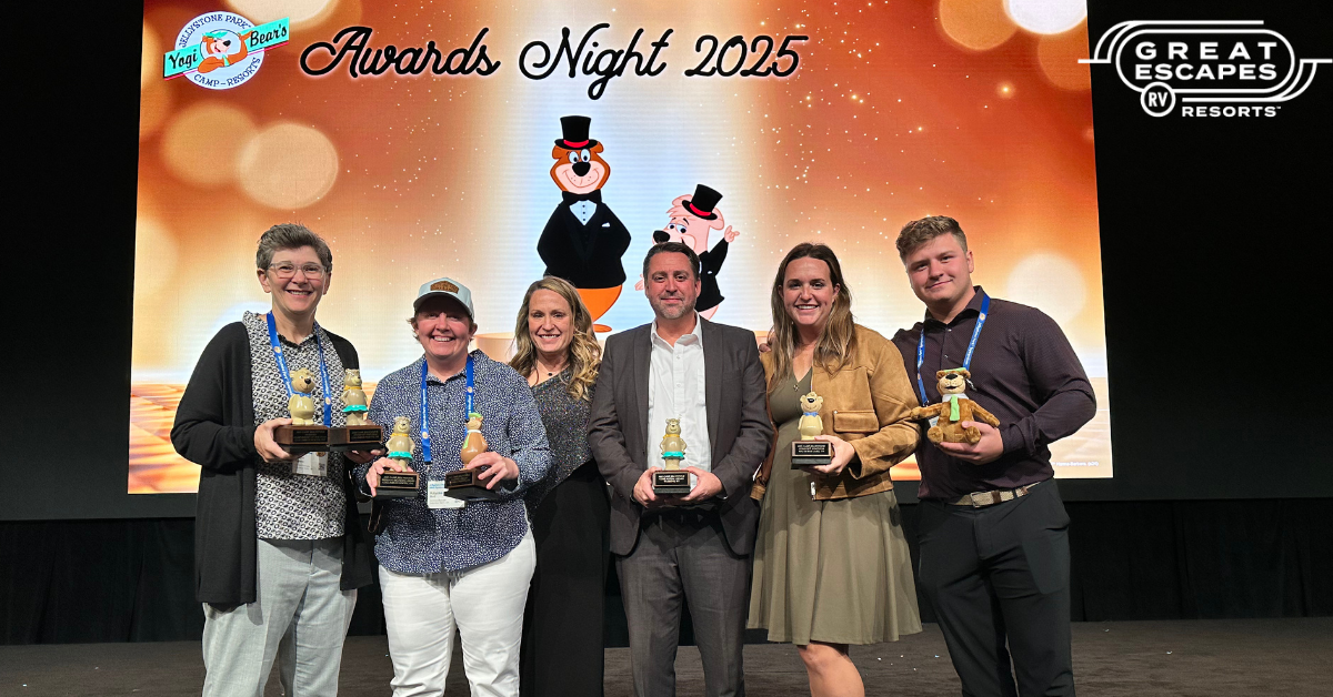 Great Escapes RV Resorts staff at the 2025 Camp Jellystone Symposium awards with their trophies.