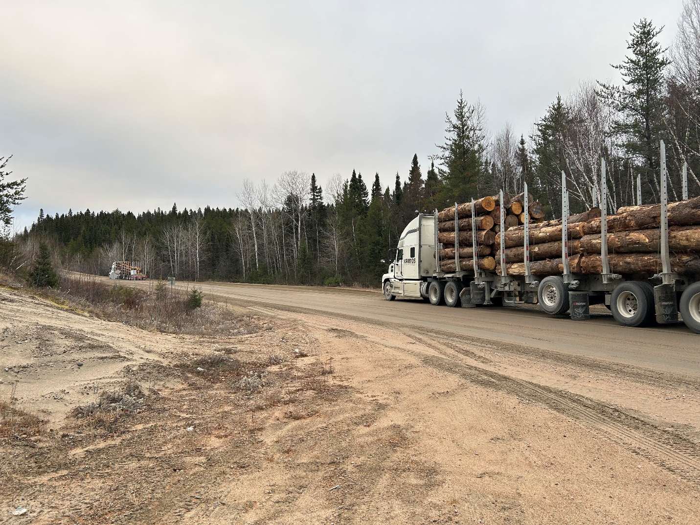 Trucks operating in automated platooning mode with a human-driven lead truck paired to a driverless follower hauling timber along forestry supply chain routes in Québec Canada