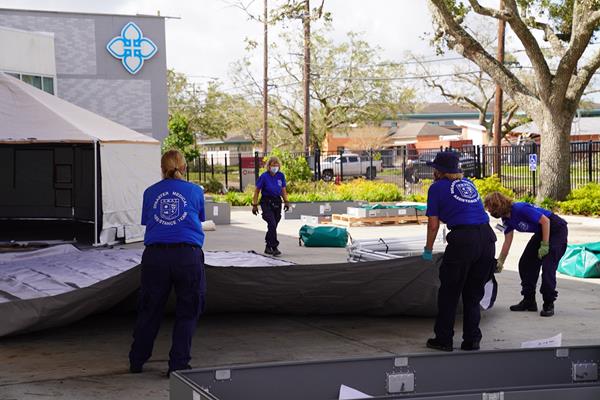 A Disaster Medical Assistance Team sets up tents at Lake Charles Memorial Hospital to provide support in response to Hurricane Laura. Responders like these are processed using F/ERO ATS. FEMA photo