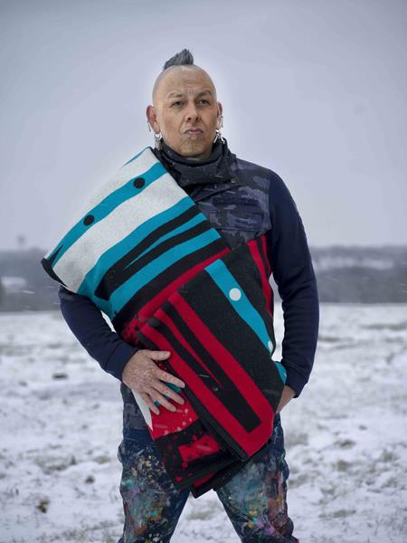 Pawnee-Yakama artist Bunky Echo-Hawk poses with the blanket he designed in honor of Wieden+Kennedy co-founder David Kennedy. Photo: Thomas Ryan RedCorn.