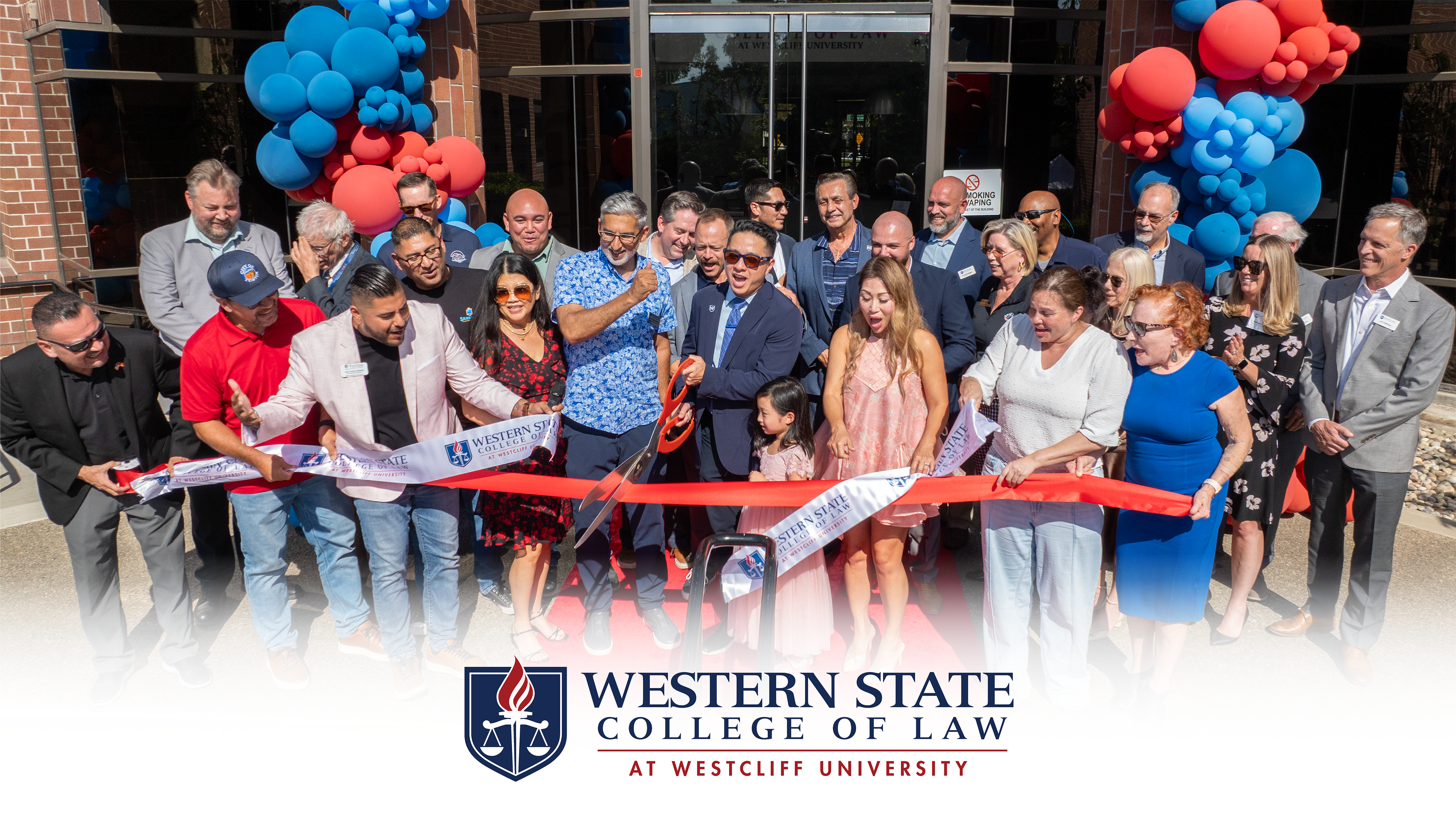 Officials cut a ribbon at Western State College of Law's 60th anniversary and Tustin campus grand opening.