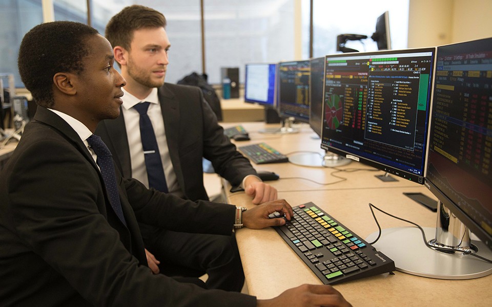 Students use the Bloomberg financial terminals at the EMU College of Business