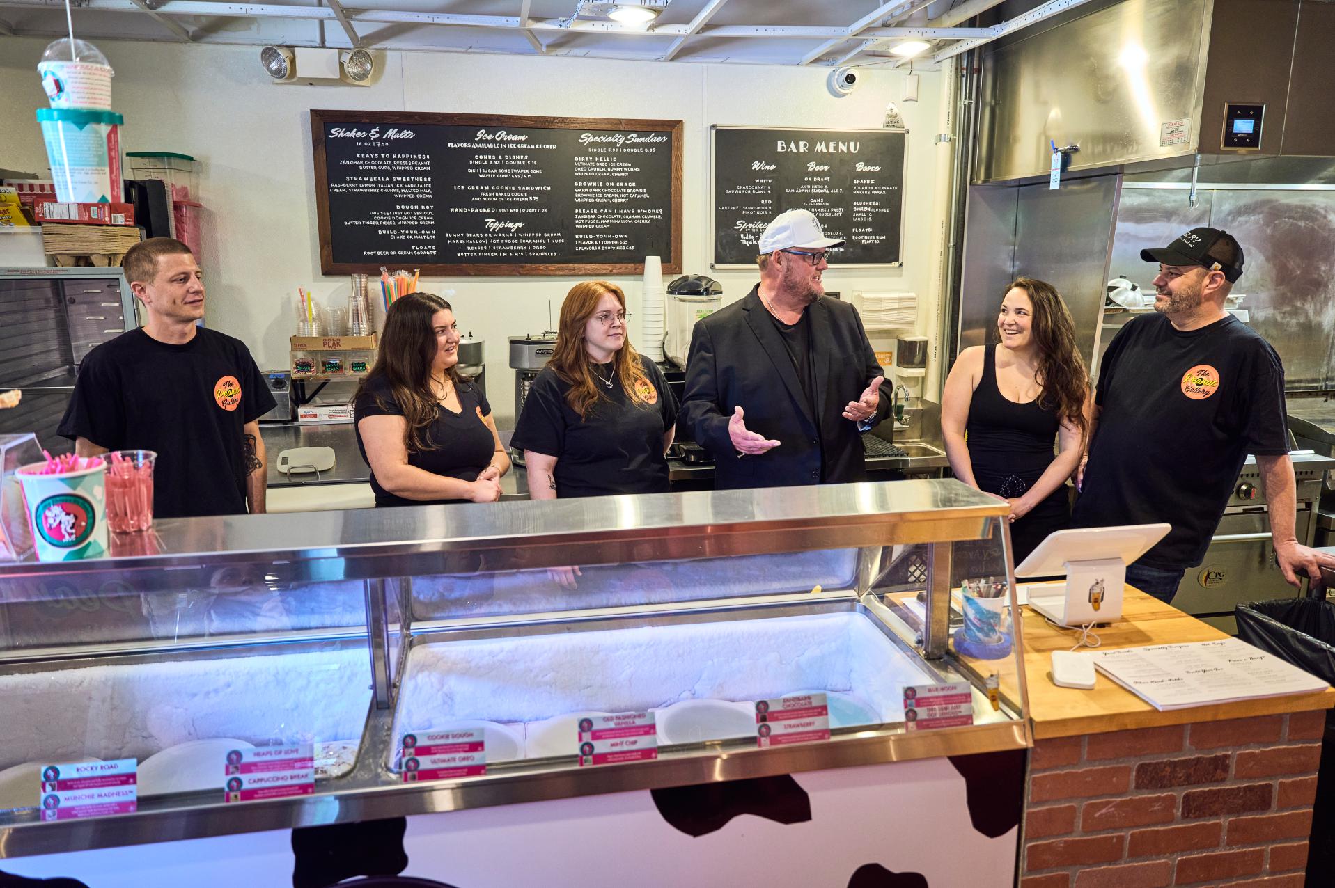 Chef Beau MacMillan (third from right) visits The Peanut Gallery to surprise Chef Dominic Zumpano (far right), Cecilia Lanyon (second from right) and restaurant staff with the Service Superstar Award from McCain Foods, which recognizes foodservice professionals who go above and beyond to serve their customers and community.