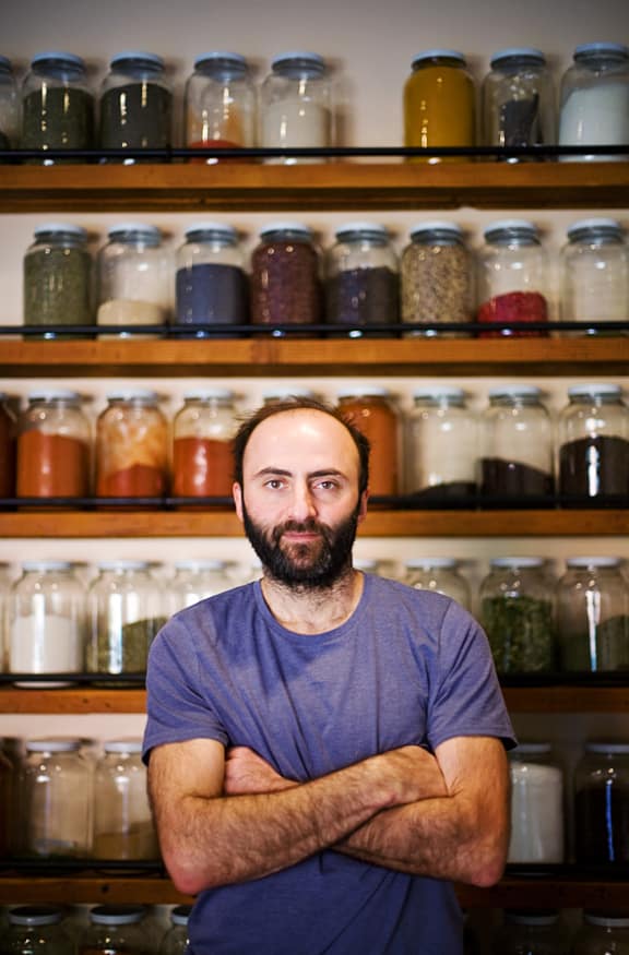 Peter and his wall of spices at his original spice store location in Silverlake.