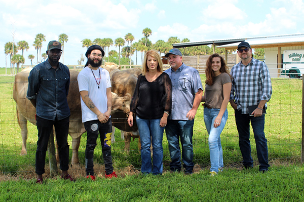The four artists visited with local farmers Sutton and Kris Rucks (middle) at their farm before beginning the masterpiece (L-R: Peterson Guerrier, Michael Caban, Kris Rucks, Sutton Rucks, Catalina Penagos and Chris Jones). 