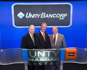 Allen Tucker, retired Vice Chairman of the Unity Bank Board of Directors, (from left) James A. Hughes, Unity President & CEO, and David Dallas, Chairman of the Unity Board of Directors, at Nasdaq MarketSite at Times Square.