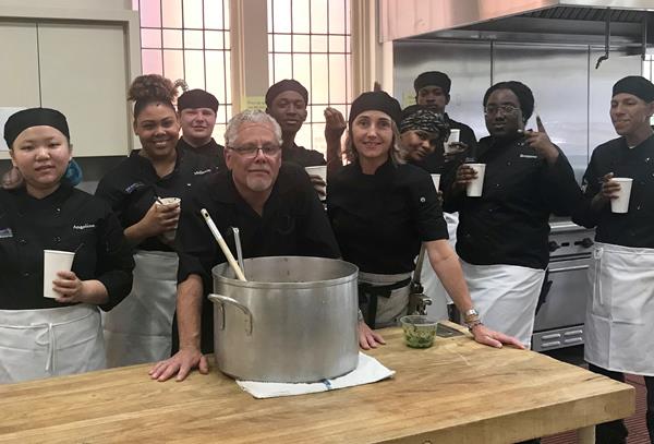 Chef apprentices relax after cooking their first dish, minestrone soup with pesto. Professional chefs, first row center, Claud Beltran and Alexandra Poer, were their mentors for the day. 