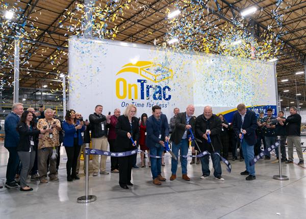 OnTrac leadership team and dignitaries cut grand opening ribbon at new facility