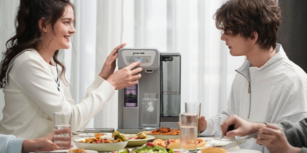 A girl is using the Glacier Fresh Coolon Cold Water Dispenser to serve her family