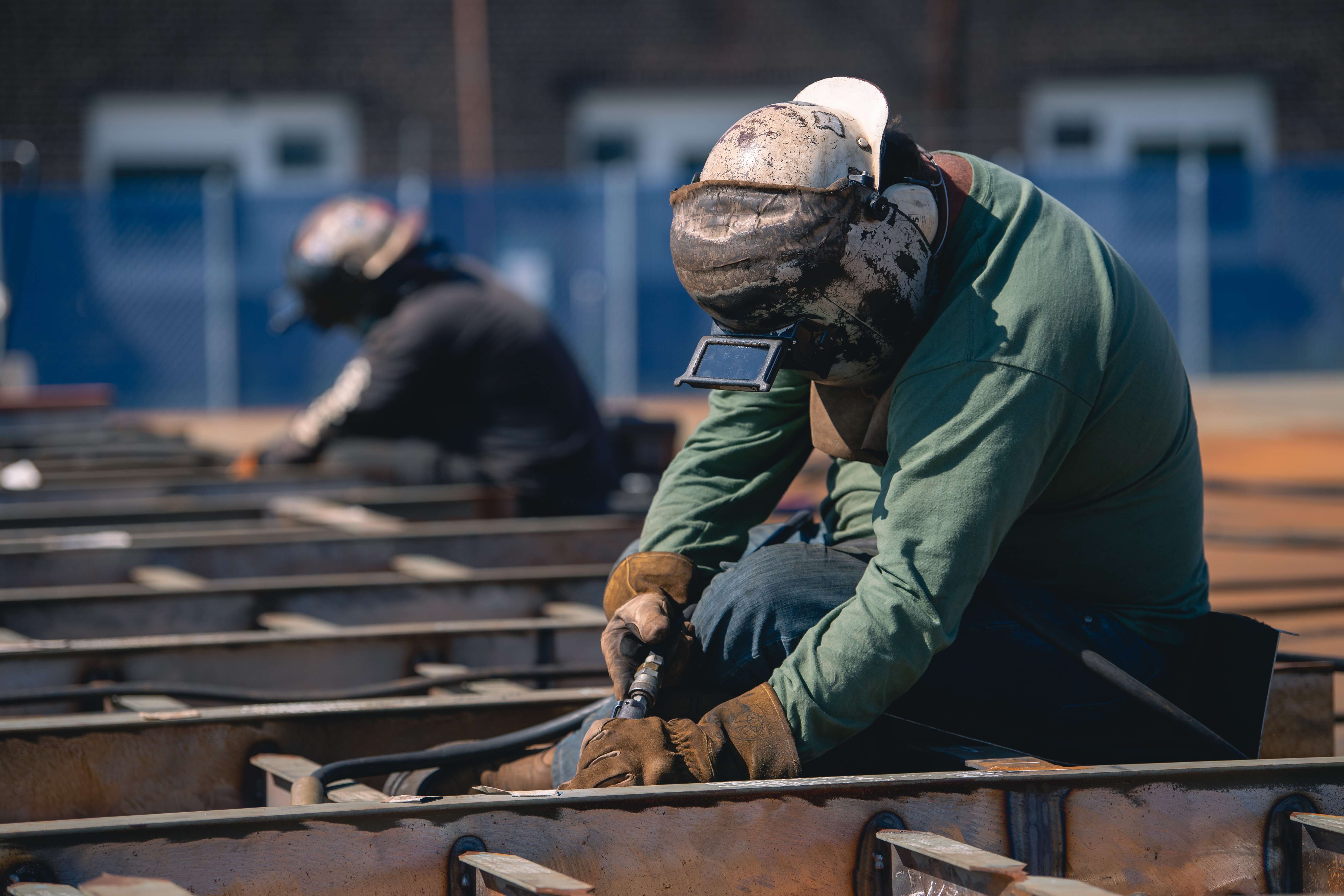 A welder works on a steel panel at the Newport News Shipbuilding Norfolk Campus (Photo by Ashley Cowan/HII)