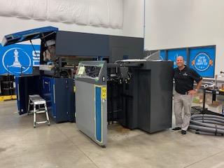 Keith Miller, CEO, Strategic Factory in front of his newly installed AccurioJet KM-1 LED UV Inkjet Press