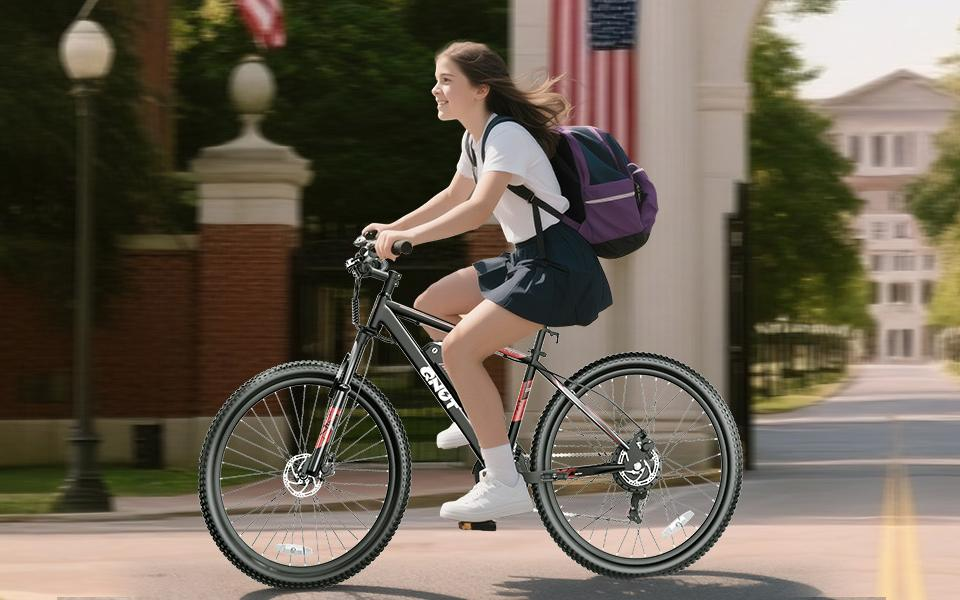 A woman riding a Qnut eBike on a city street.