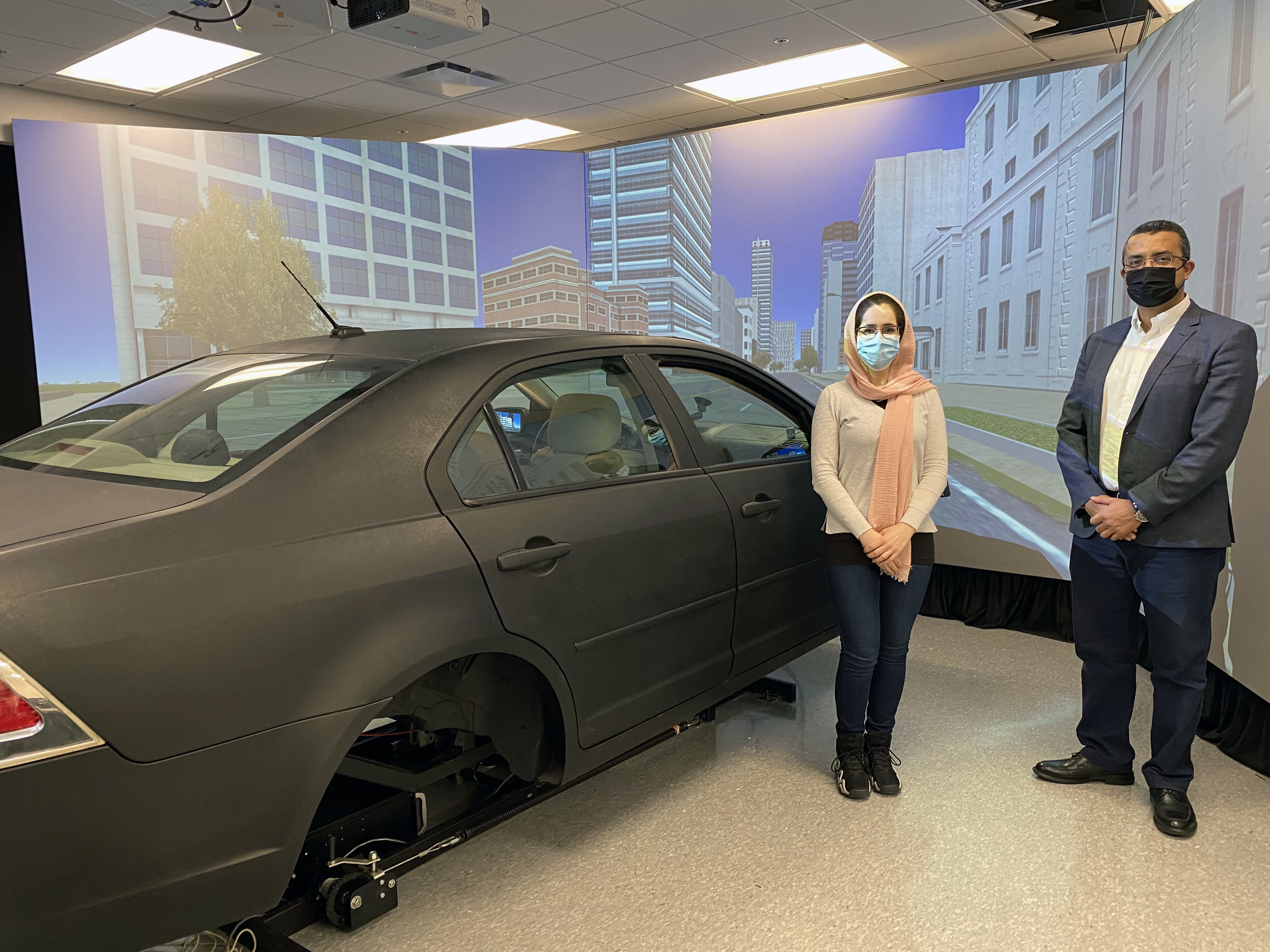 LSU Civil Engineering Assistant Professor Hany Hassan (right) conducts research in the college's driving simulator as part of his study into senior citizens' driving behavior in various traffic and environmental conditions.