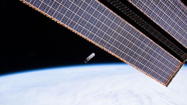The Hyper-Angular Rainbow Polarimeter small satellite is shown in this February 19, 2020, photo shortly after it was deployed into orbit from the International Space Station. Manufactured by the Space Dynamics Laboratory to carry the payload built by the Earth and Space Institute at the University of Maryland, Baltimore County, the HARP satellite was honored with the Small Satellite Mission of the Year award today.  (Credit: NASA)