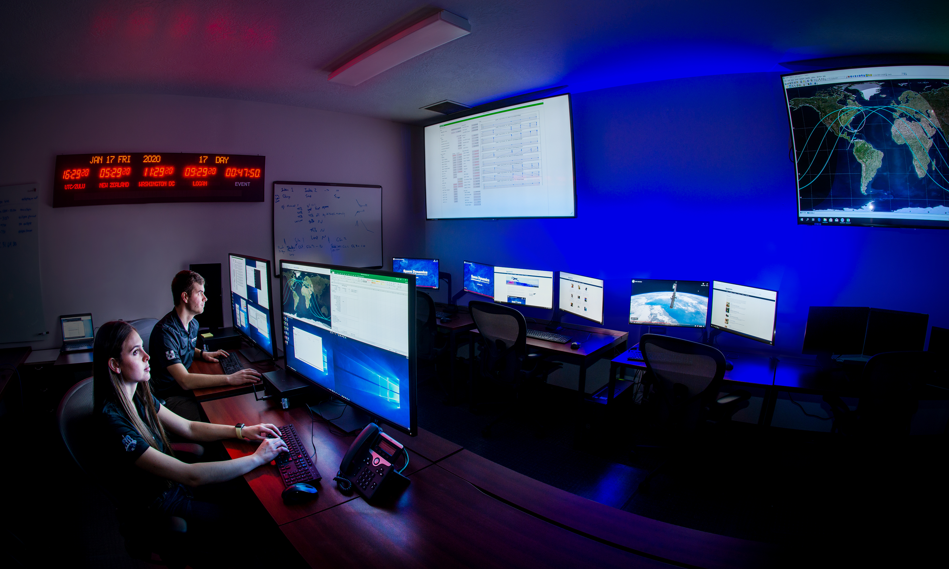 Space Dynamics Laboratory small satellite operators are shown in this January 17, 2020 photo at the controls of one of SDL’s Mission Operations Centers. (Credit: Space Dynamics Laboratory/Allison Bills)