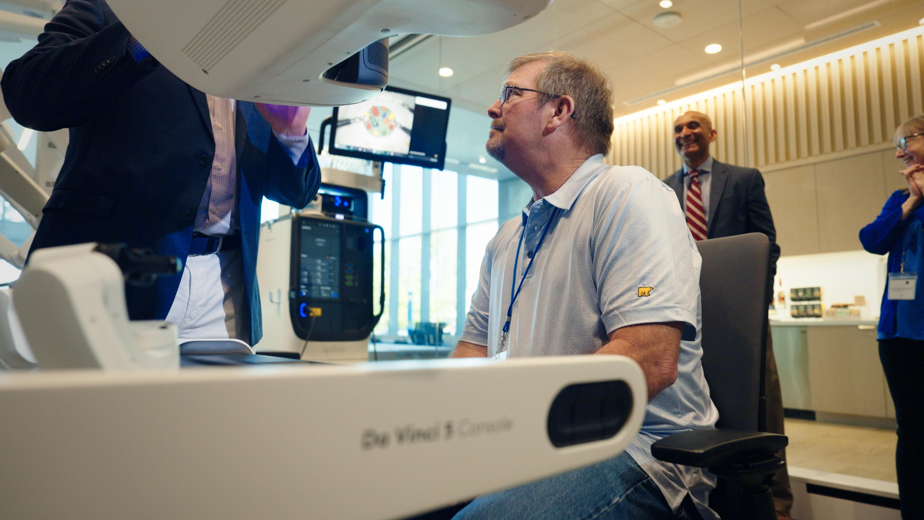 Patient Dan Larson takes a turn at a da Vinci 5 robotic platform on the day of his visit to Intuitive in Sunnyvale, CA.