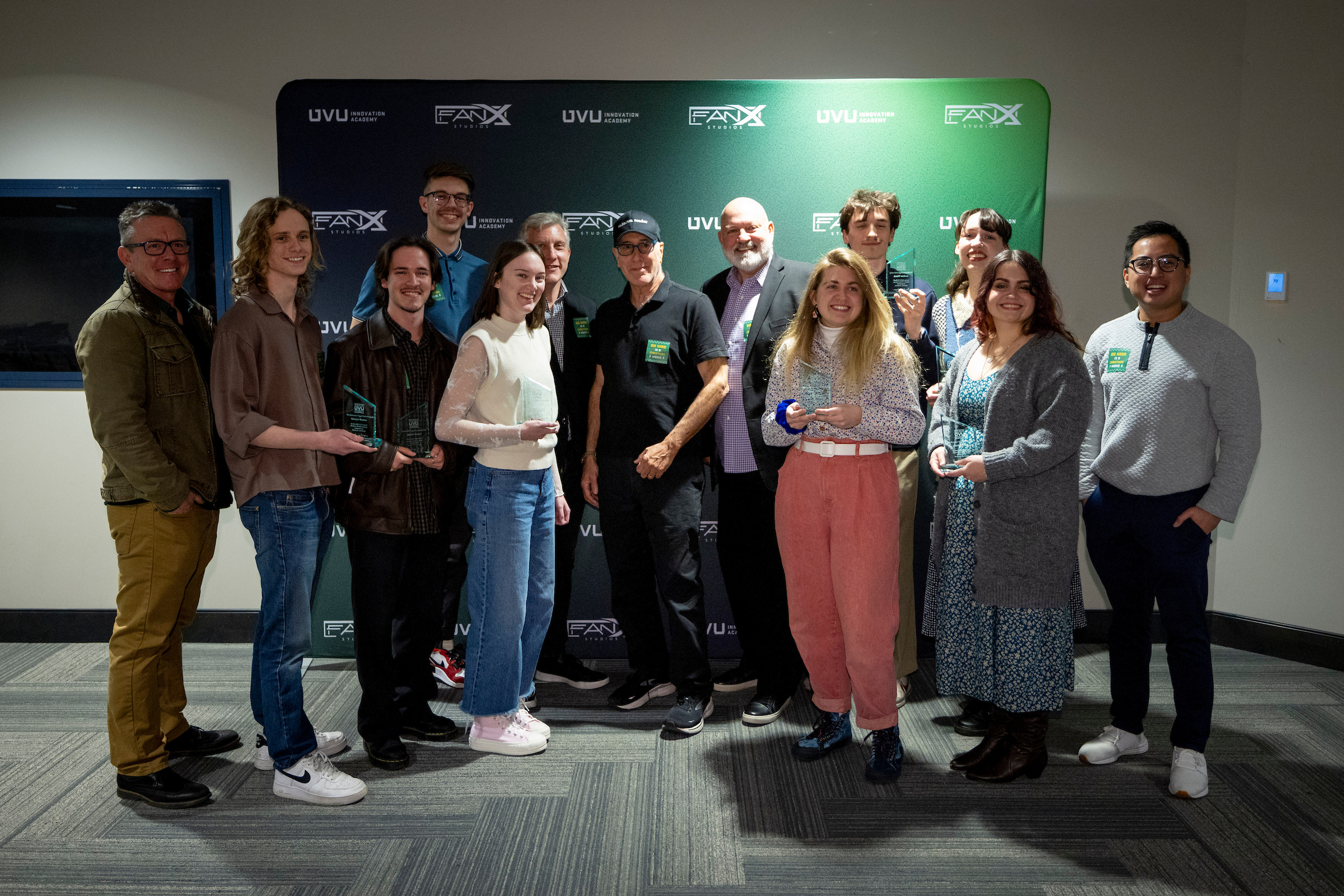 Eight UVU film students selected to participate in the 2025 UVU/FanX Studios Writer's Room pose with film legend Steven E. de Souza and Brent Baum, CEO of FanX Studios