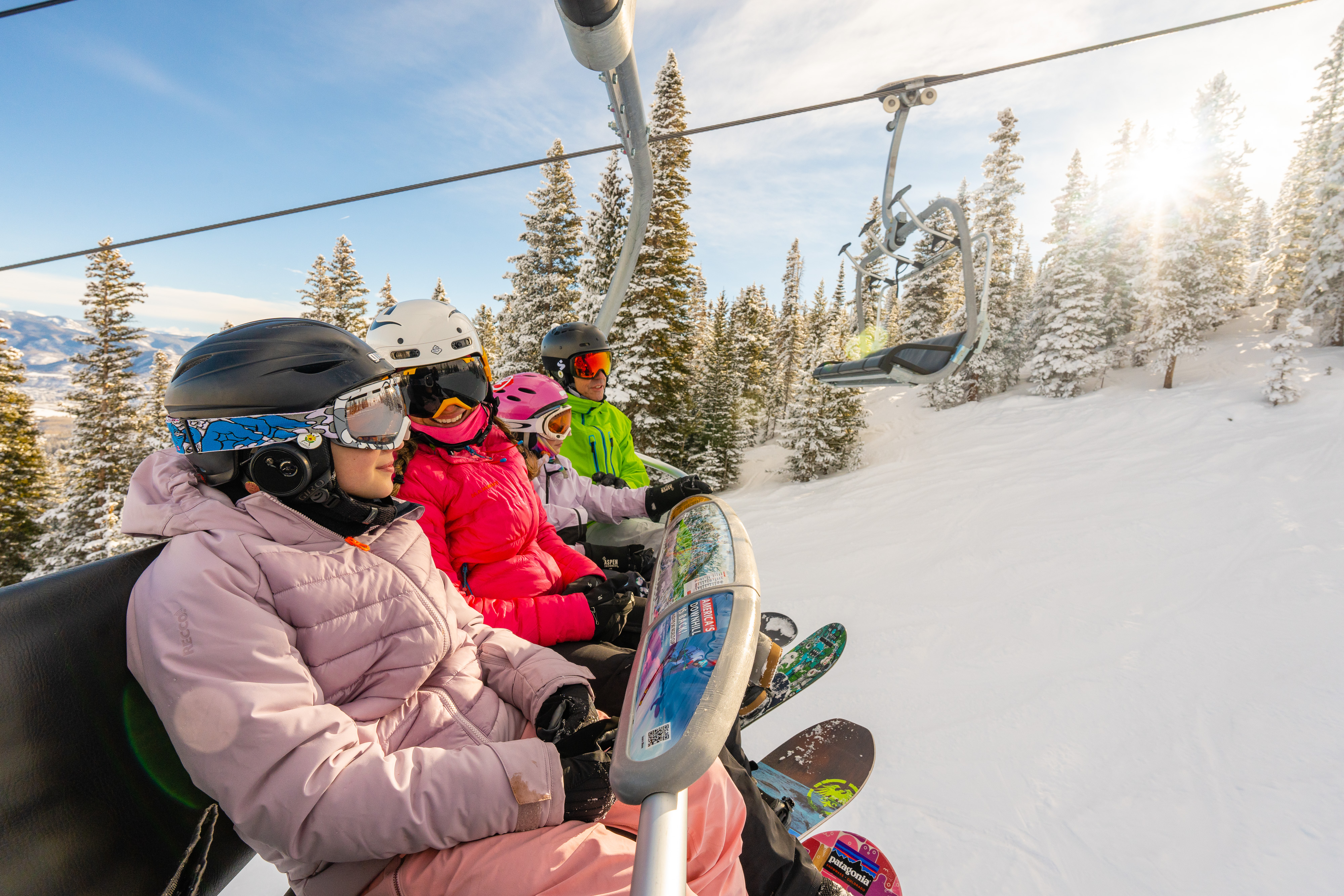 A family enjoys a bluebird day on Aspen Mountain