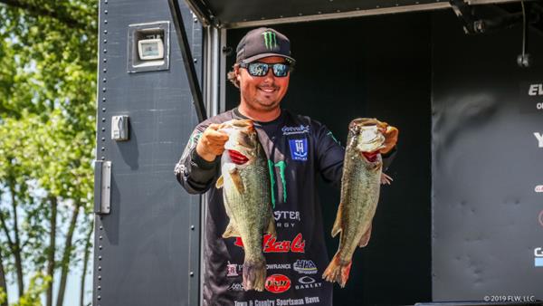 FLW Tour pro Tyler Stewart holds up two keepers for the cameras after Day One of the FLW Tour on Lake Champlain presented by T-H Marine. (Kyle Wood)