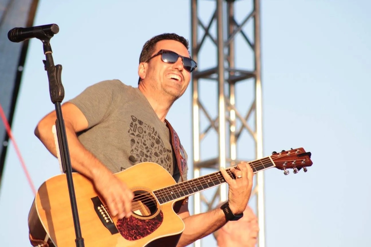 Country music artist Jason Brown performing on stage with guitar