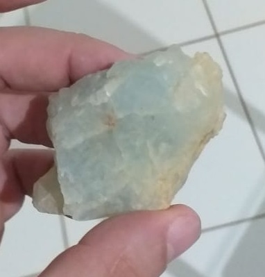 Mr. Areli holding a sample of hard-rock spodumene