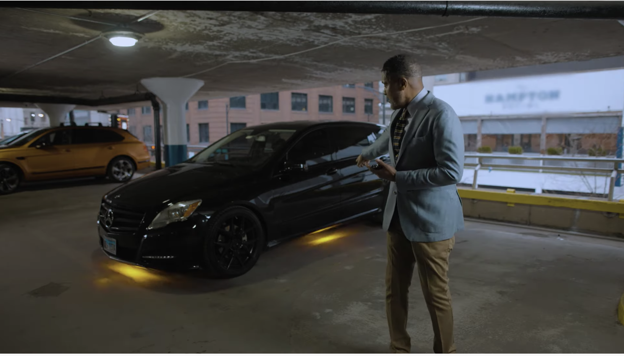 Dr. William Yates demonstrates The Yates Device on a black car with blinking lights and sirens