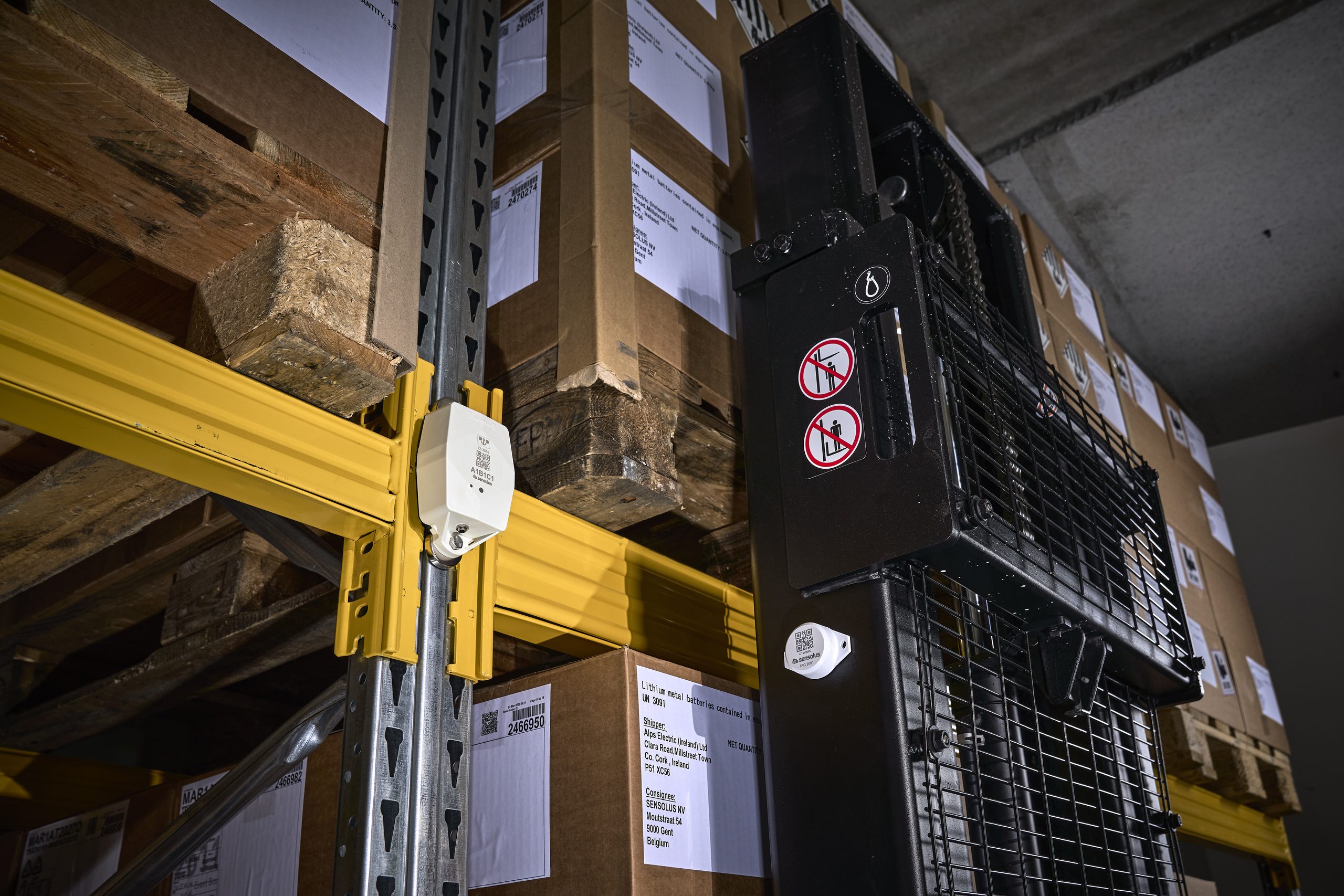 Sensolus trackers deployed on warehouse racking and equipment, illustrating how the devices are installed in the field. Not a Pratt & Whitney Canada site.