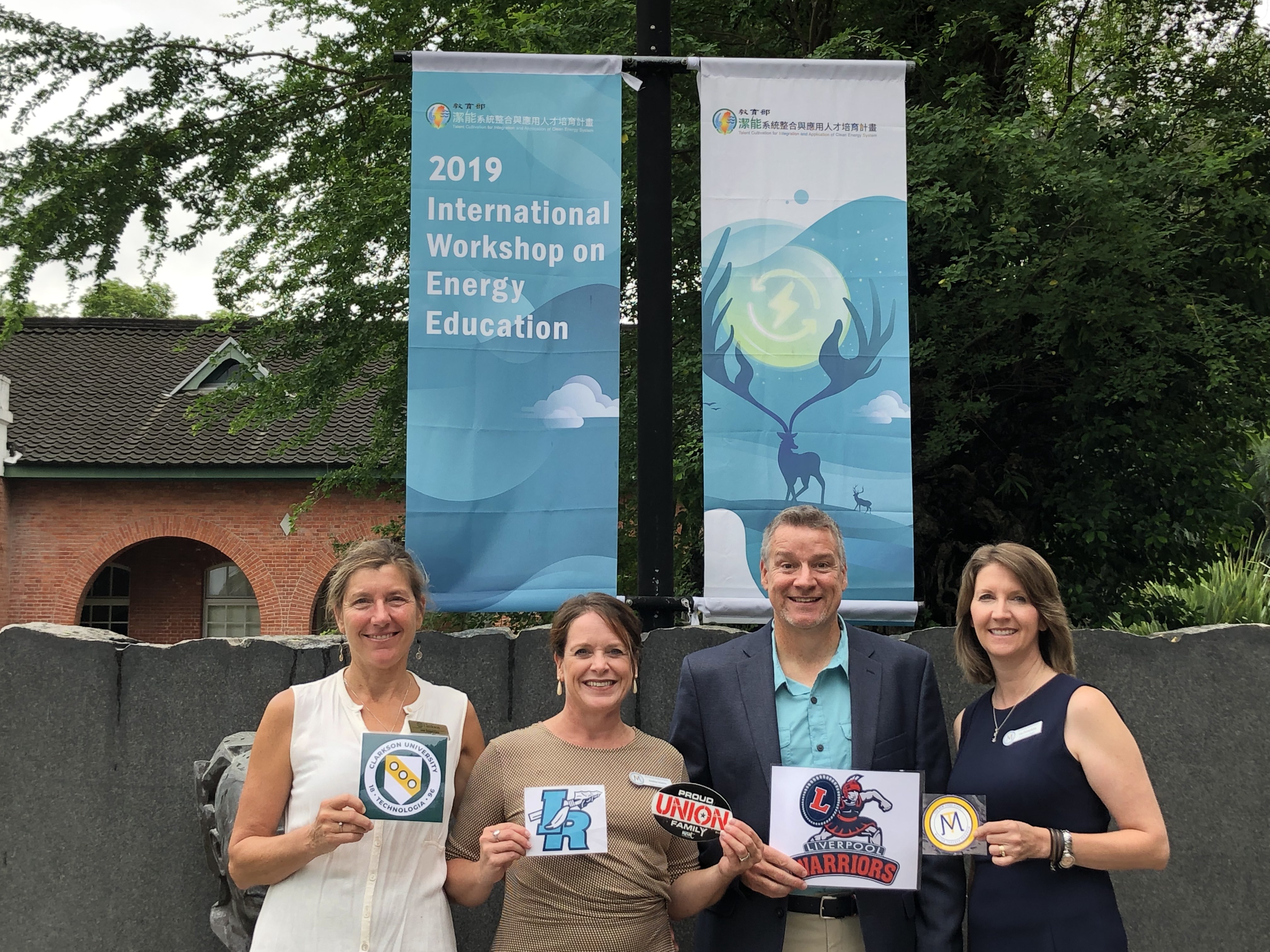 L-R: Jan DeWaters, Andrea Inserra, Andrew Calderwood, & Lisa Dunkelberg are pictured with their respective school placards at the workshop they attended